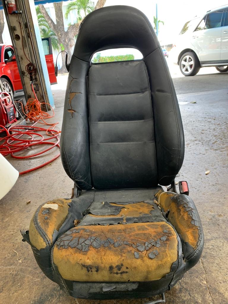 Damaged worn car seat before professional leather restoration Ranger Seat Cover Miami